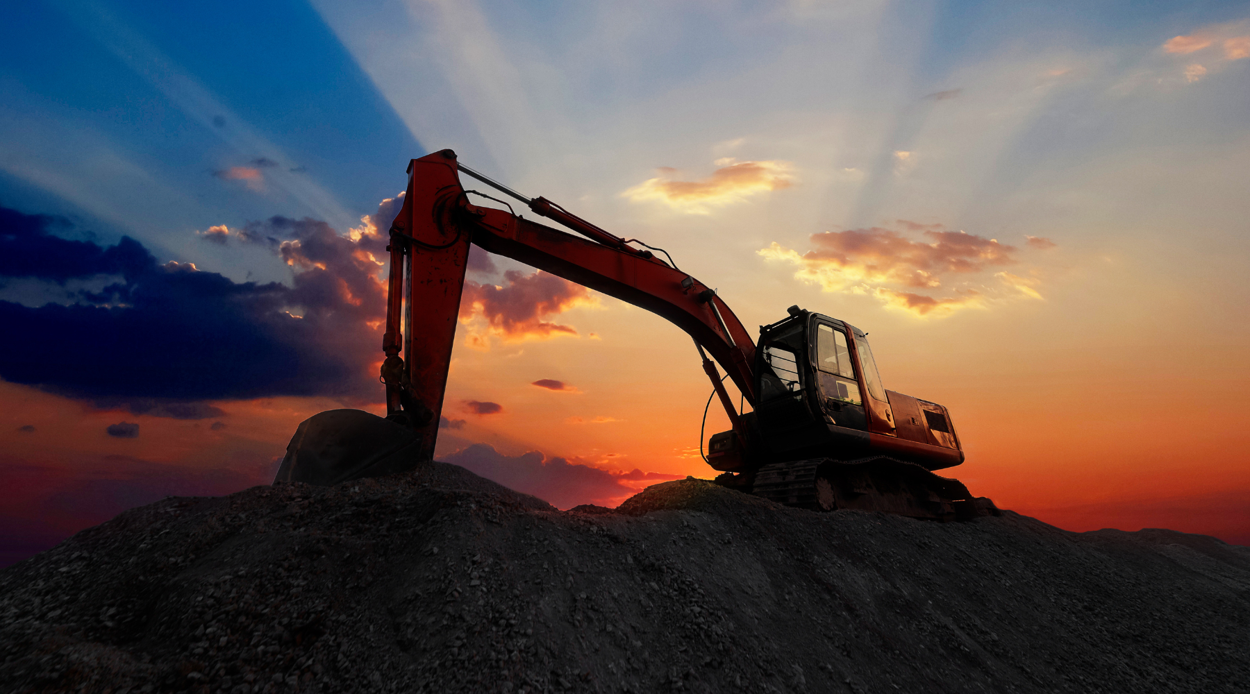 Excavator on a hill at dusk